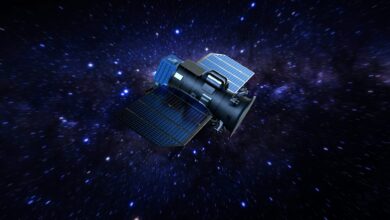 An artist's rendering of a satellite in space. The satellite is seen floating amongst the stars in a dark blue region in space.