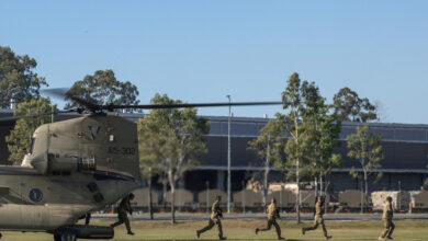 Australian Army riflemen from Alpha Company of the 8th/9th Battalion, The Royal Australian Regiment rehearse disembarking drills off a CH-47 Chinook during an Air Mobile Operation familiarisation and integration training exercise at Gallipoli Barracks, Brisbane. *** Local Caption *** Soldiers from Battle Group Ram, centred on, 8th/9th Battalion, The Royal Australian Regiment (8/9 RAR), took part in CH-47 Chinook integration training at Gallipoli Barracks, Brisbane, in June. The activity was supported by 5th Aviation Regiment. Soldiers conducted loading and offloading drills, refining their skills for air mobile operations. The training enhances Battle Group Rams readiness for major exercises such as Exercise Diamond Strike or operational deployments.