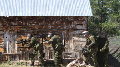 Soldiers of Task Force 41, Canadian Army, prepare to enter a building at the urban patrol training lane on West Camp Rapid, Rapid City, S.D., on June 16, 2016. This event was a part of the 32nd South Dakota National Guard Golden Coyote training exercise.