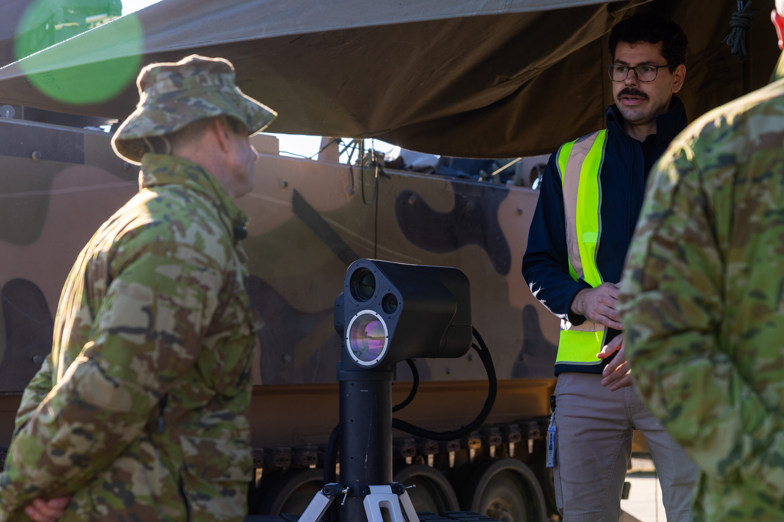 AIM Defence co-founder Dr Jae Daniel explains the operation of the AIM Defence Counter-UAS Directed Energy Weapons System to Australian Army Director General Future Land Warfare Brigadier James Davis at the Puckapunyal Military Area, Victoria. *** Local Caption *** The AIM Defence Counter-UAS Directed Energy Weapons System live-fire demonstration is the final stage of a joint RICO/Jericho investment spanning over five years. AIM Defence design, build, test, and manufacture high-powered laser solutions. The demonstration took place in Puckapunyal, Victoria on 27-31 May 2024 and showcased the Fractl Portable High Energy Laser and how it can be used by the Australian Army.