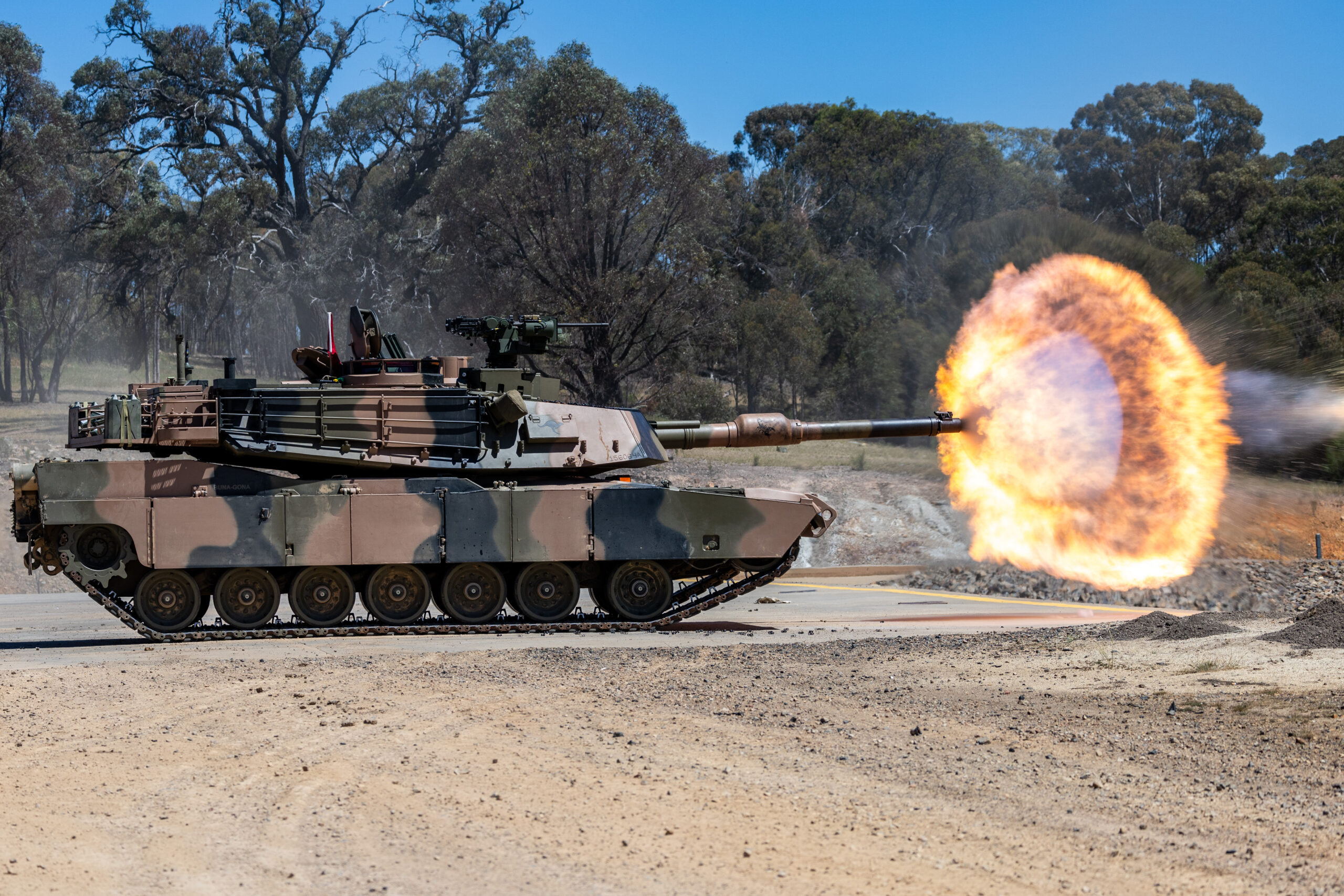 An Australian M1A2 SEP v3 Main Battle Tank fires a sabot round during a live fire to confirm the aiming system of the tank and to qualify crews on the new systems at the Puckapunyal Military Area, Victoria, 05 November 2024. *** Local Caption *** Armys combined arms fighting system will be modernised through the delivery of LAND 907. LAND 907 will deliver M1A2 Abrams System Enhancement Package version 3 (SEPv3) main battle tanks (MBTs). LAND 907 will also deliver the assault breacher vehicle (ABV) and joint assault bridge (JAB) collectively known as the combat engineering vehicles (CEV). The MBT and CEV are manufactured in the United States of America in Alabama, Ohio and Missouri before being shipped to Australia from the United States of America. The initial block of MBT, comprising 27 vehicles, departed the US in late June and arrived in Australia in August 2024. The initial block of CEV will also be shipped to Australia, arriving in 2025. In accordance with outcomes of the 2024 National Defence Strategy, the MBT and CEV will be located in Townsville as part of the 3rd Brigades 2nd Cavalry Regiment and 3rd Combat Engineer Regiment respectively, with small fleets located in Puckapunyal and Wodonga.