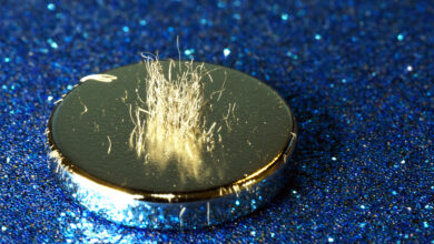 Metal shavings stand vertically atop a rare earth magnet