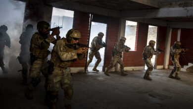 Peruvian commandos make entry into a building during urban operations training as part of exercise Resolute Sentinel 24 at Base Naval De Infanteria De Marina, Lima, Peru, June 6, 2024. The commandos practiced using smoke and flash grenades to mimic close contact engagements in urban combat environments, enhancing their readiness and tactical skills. RS24 is a U.S. Southern Command sponsored exercise that consists of comprehensive joint training opportunities aimed at enhancing regional security and interoperability among the United States, France, Peru, Colombia, Ecuador, Chile, and Brazil. (U.S. Marine Corps photo by Cpl. Samuel Qin)