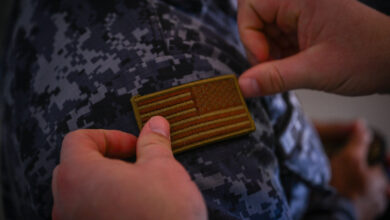 U.S. Air Force Master Sgt. Eddie Morgan, 571st Mobility Support Squadron training operations superintendent, puts a U.S. flag patch on Cápitan 2do. De Infantería Erlin Omar Reyna De Leon with Comando Aéreo Central (CACEN) for a tradition of trading patches and as a sign of respect after a base tour concluded at CACEN “La Aurora” in Guatemala City, Guatemala, Feb. 20, 2024. Guatemala 23-23 was a month-long training mission between the 571st Mobility Support Advisory Squadron’s mobile training team and the Guatemalan Air Force that was centered around logistics readiness, material management and aircraft maintenance. (U.S. Air Force photo by Staff Sgt. Scott Warner)
