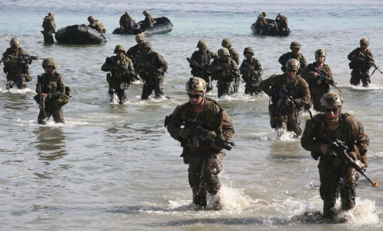 Philippine and US Marines simulate a beach landing from combat rubber raiding crafts onto a small island off the coast of Palawan, Philippines