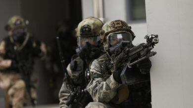 U.S. Army soldier assigned to the 5th Battalion, 20th Infantry Regiment, 1-2nd Stryker Brigade Combat Team, offers covered fire for squad members during a military operation on urban terrain training on March 17, 2025, in South Korea. The exercise focuses on enhancing urban warfare skills, improving coordination, and strengthening interoperability between both forces in complex, close-quarters environments. (U.S. Army photo by Sgt. Oniel McDonald)