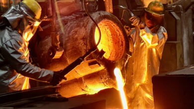 Foundry artisans fill a mold to manufacture cast parts at Stainless Foundry and Engineering in Wisconsin