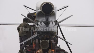 Workers and military inspect Ukrainian Fire Point's Flamingo missiles during handover to the military in an undisclosed location in Ukraine Thursday, Dec. 4, 2025. (AP Photo/Efrem Lukatsky)