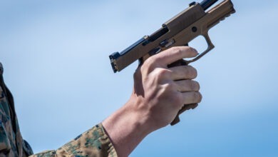 A U.S. Marine clears a P320-M18 Sig Sauer during the Marine Corps Marksmanship Competition West (MCMC-West) at Range 214 on Marine Corps Base Camp Pendleton, California, Feb. 21, 2023. MCMC-West provides an opportunity to refine the fundamental skills that make a Marine lethal on the battlefield and able to deliver lethal force in a dynamic environment. (U.S. Marine Corps photo by Lance Cpl. Mhecaela J. Watts)