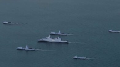 hybrid naval fleet comprising crewed and uncrewed vessels on sea