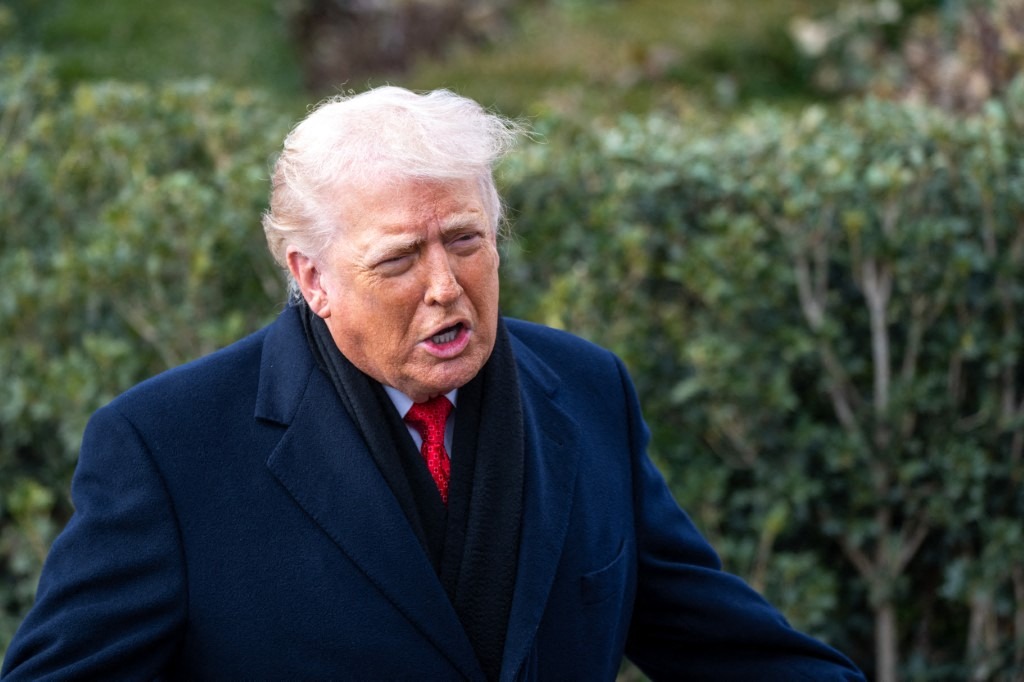 US President Donald Trump speaks to the media as he departs the White House