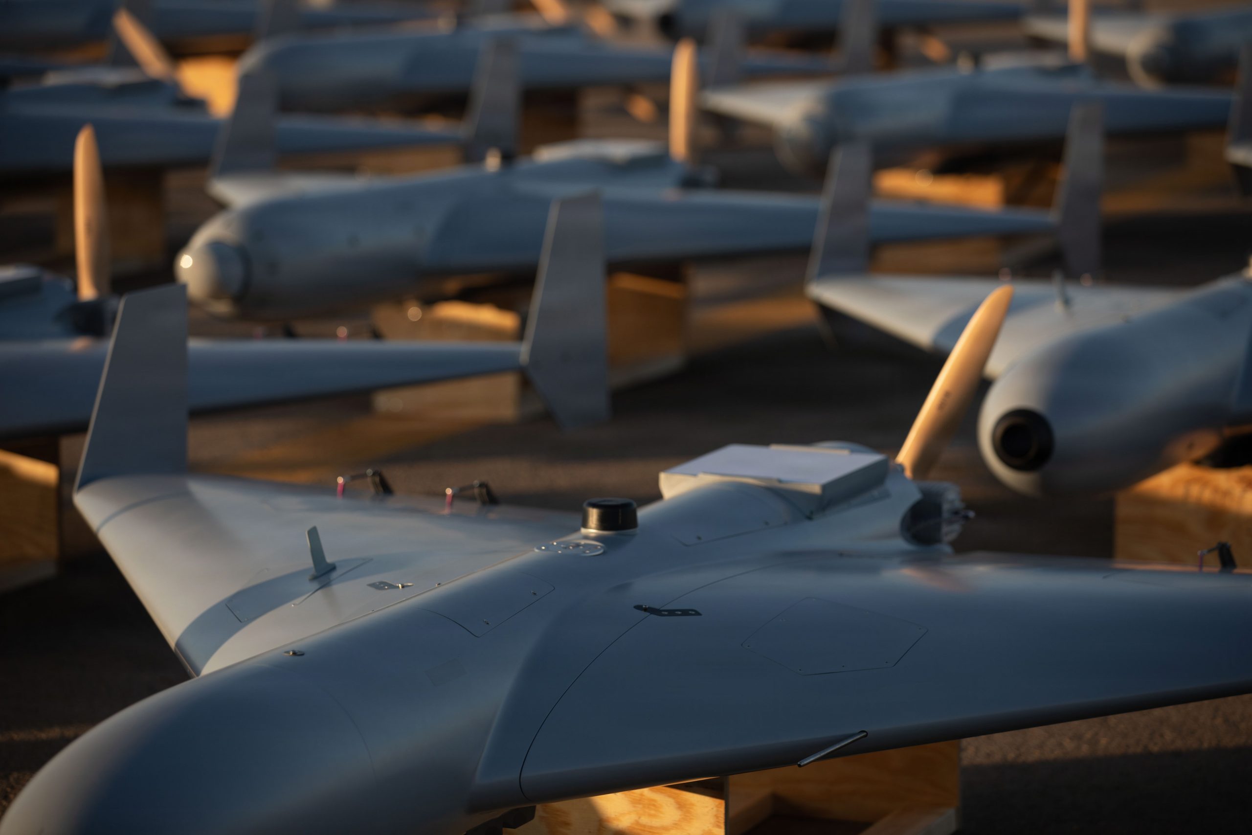 U.S. CENTRAL COMMAND AREA OF RESPONSIBILITY (Nov. 23, 2025) Low-cost Unmanned Combat Attack System (LUCAS) drones are positioned on the tarmac at a base in the U.S. Central Command (CENTCOM) operating area, Nov. 23. The LUCAS platforms are part of a one-way attack drone squadron CENTCOM recently deployed to the Middle East to strengthen regional security and deterrence. (Courtesy Photo)